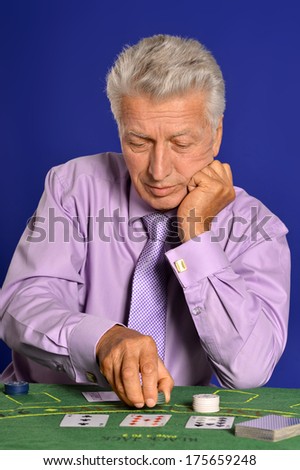 Senior man playing in casino