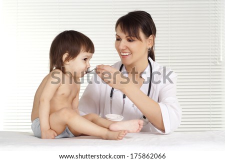 Cute doctor with little girl on white