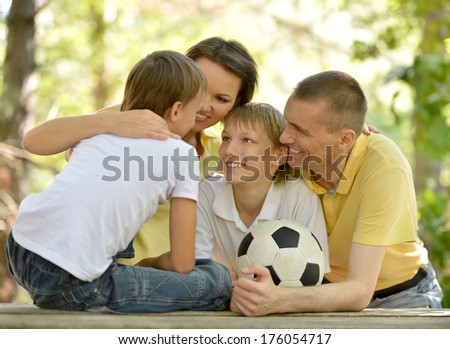 Happy family having nice time in summer park