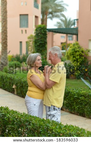 Senior couple run at tropic hotel resort