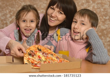 Portrait of a cute family eating pizza