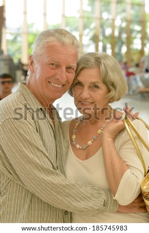 Cute happy senior couple at shopping mall
