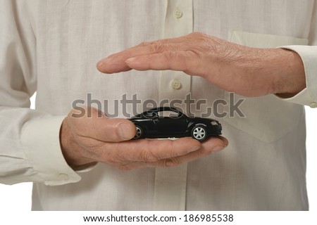 Businessman with miniature car isolated on white background