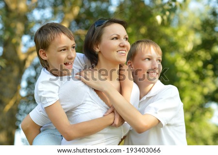 Happy beautiful mom with her sons outdoors