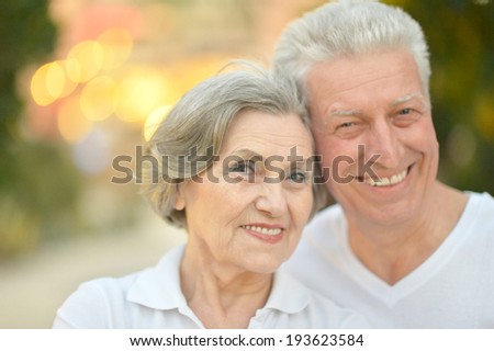 Beautiful happy old people in the summer park
