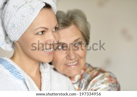 happy young woman with her elder mother at home