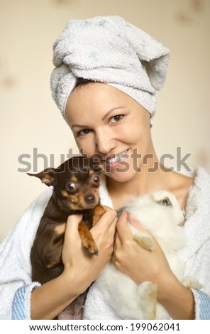 happy young woman with a dog and a rabbit