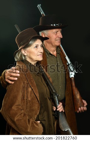 Happy Gunslingers in western garment on black