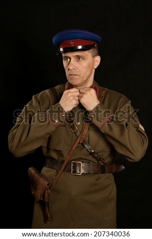 Colonel commander with a gun on a dark background
