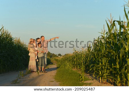 Family walking by road in field in evening