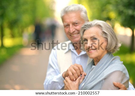 Cute smiling happy mature couple posing outdoors