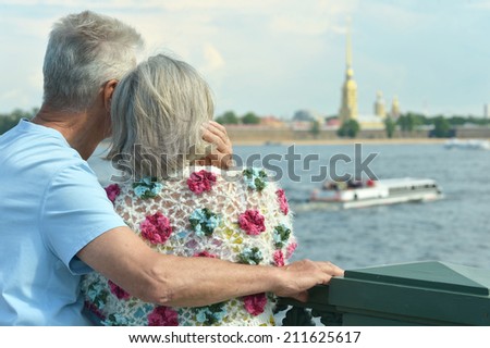 Back view of mature couple outdoors in summer