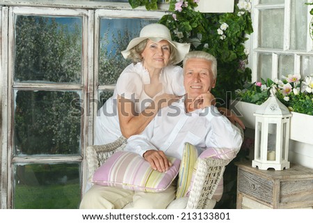 Portrait of beautiful elderly couple on wooden porch