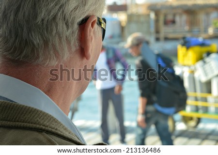 Portrait of an old man at sea resort in sunglasses