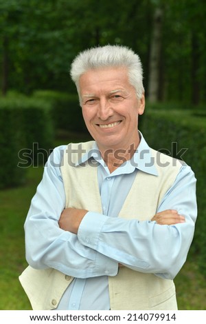 Portrait of happy elderly man in summer park