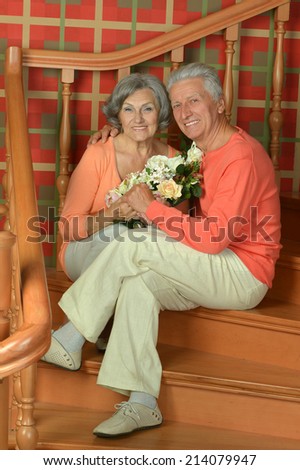 Portrait of mature couple on stairs with railing