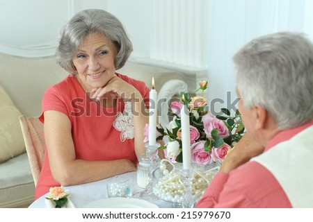Happy elderly couple together having a dinner