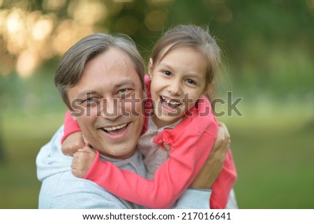 Father hugging his little daughter in nature