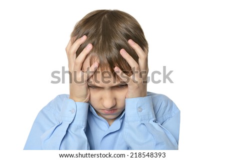 Little boy with headache on a white background