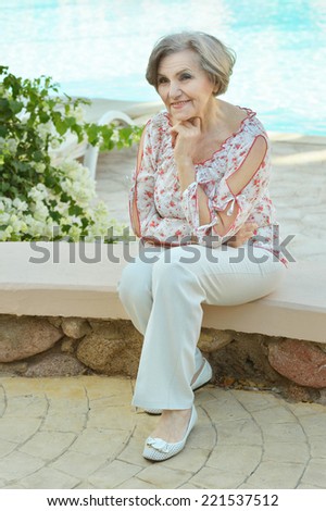 Portrait of a beautiful smiling elderly woman with flowers