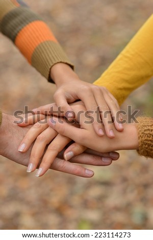 Hands held together on a natural dark background