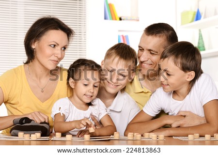 Portrait of a cute family playing at table