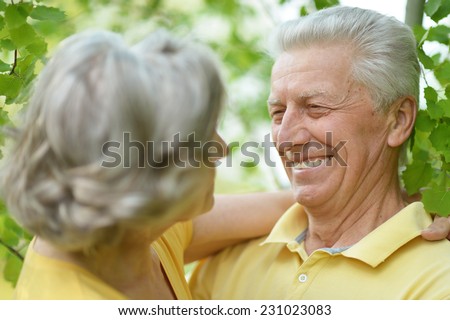 Portrait of beautiful old people embracing outdoors on the walk