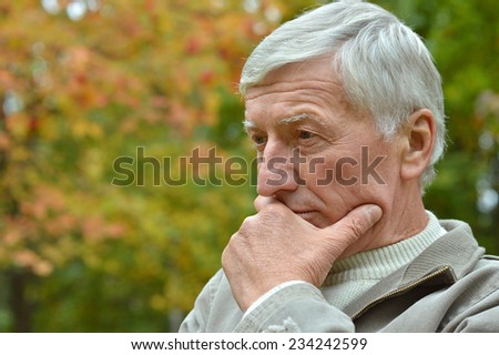 Portrait of  senior man thinking about something outdoor