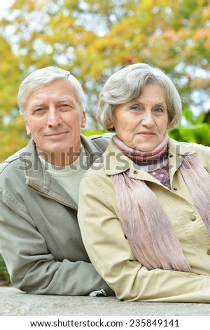 Cute elderly couple walking in the park