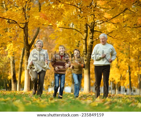 Grandparents and grandchildren together in autumn park