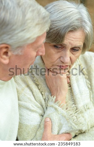 Portrait of loving elderly couple in autumn forest