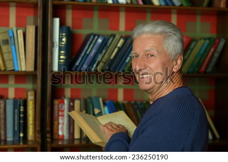 PorHandsome retired man reading booktrait of handsome retired man reading book