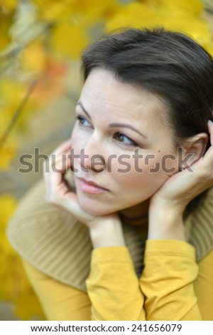 Portrait of a sad young woman in autumn park