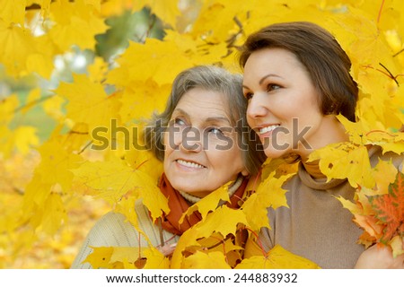 Mother and her nice daughter in autumn park