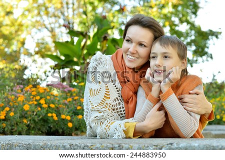 Beautiful mother with son in autumn park