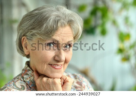 Senior woman happy at home on green background