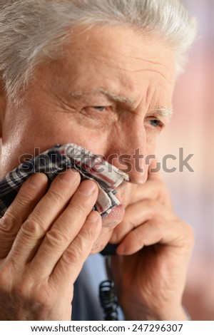 Sick old man with tooth pain call a doctor