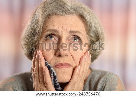Old woman with a handkerchief at home