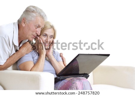 Mature couple relaxing at home on a white