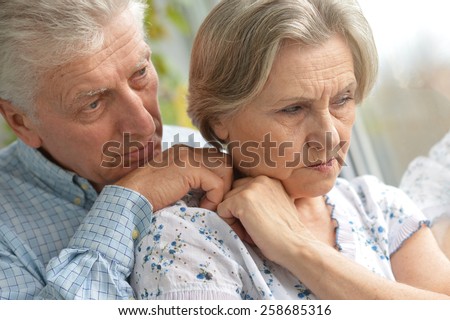 Portrait of a sad elder couple at home