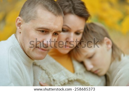 Portrait of a sad family of three on the nature