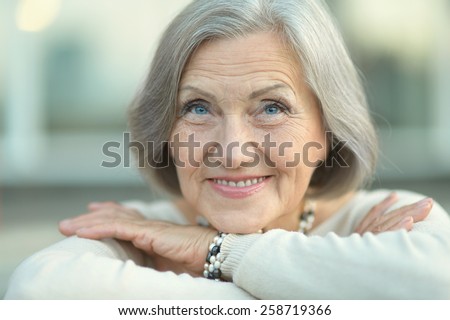 Portrait of a happy Senior woman in autumn park