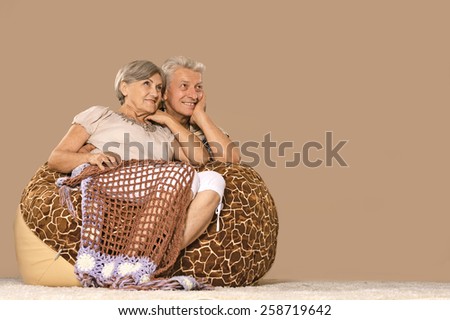 Happy elderly couple resting ,sitting on chair