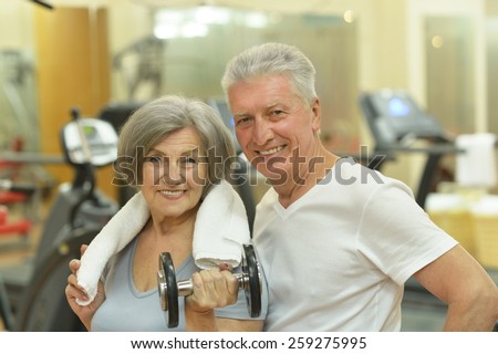 Portrait of beautiful elderly couple in gym