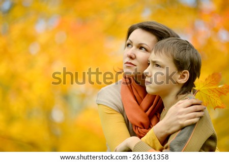 Mother with boy on walk in autumn park