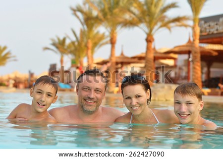 Portrait of a happy family relax in the pool