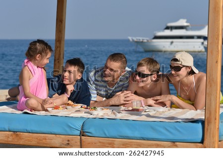 Portrait of a happy family having lunch on beach
