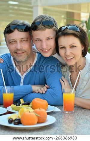 Happy family with son at breakfast on the table