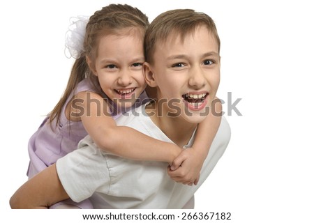 Cute little brother and sister hugging on white background