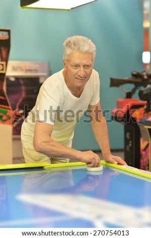 Portrait of an elderly man playing a board game